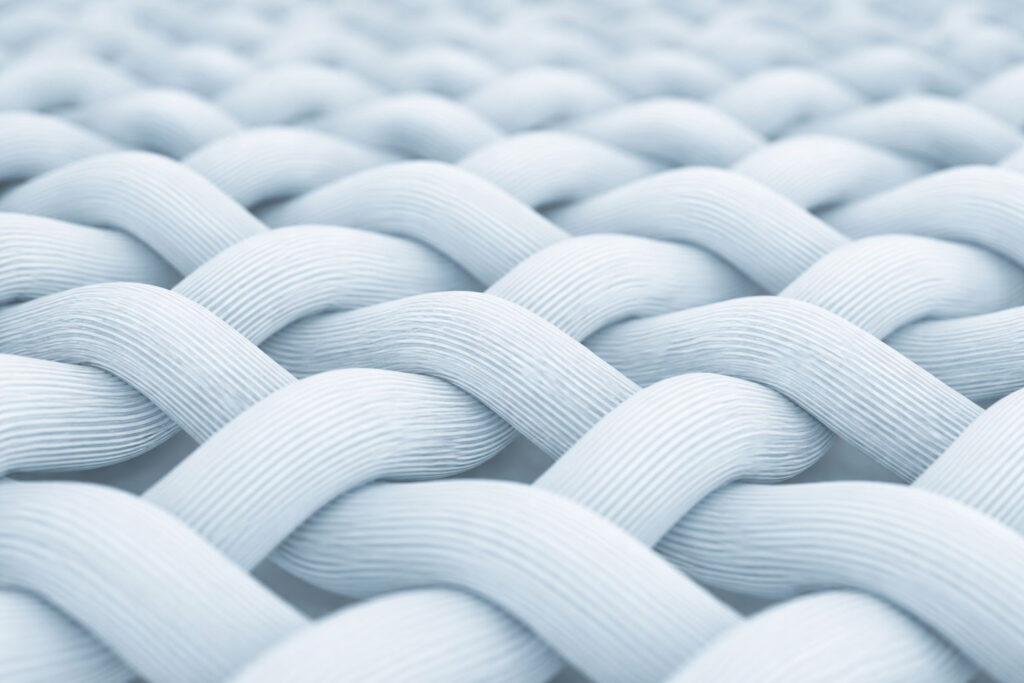 Close-up of interwoven fabric texture, illustrating that fabric type is just the starting point for consistent bulk production development