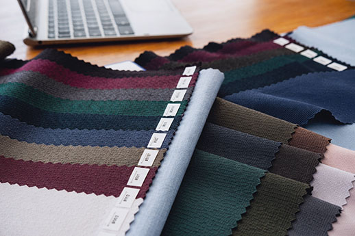 Variety of striped and colored fabrics with quality inspection tags