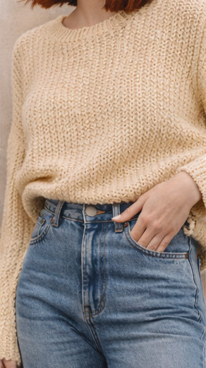 Beige knit sweater and jeans, MINYOO TEXTILE comfort-driven fabrics for casual wear.